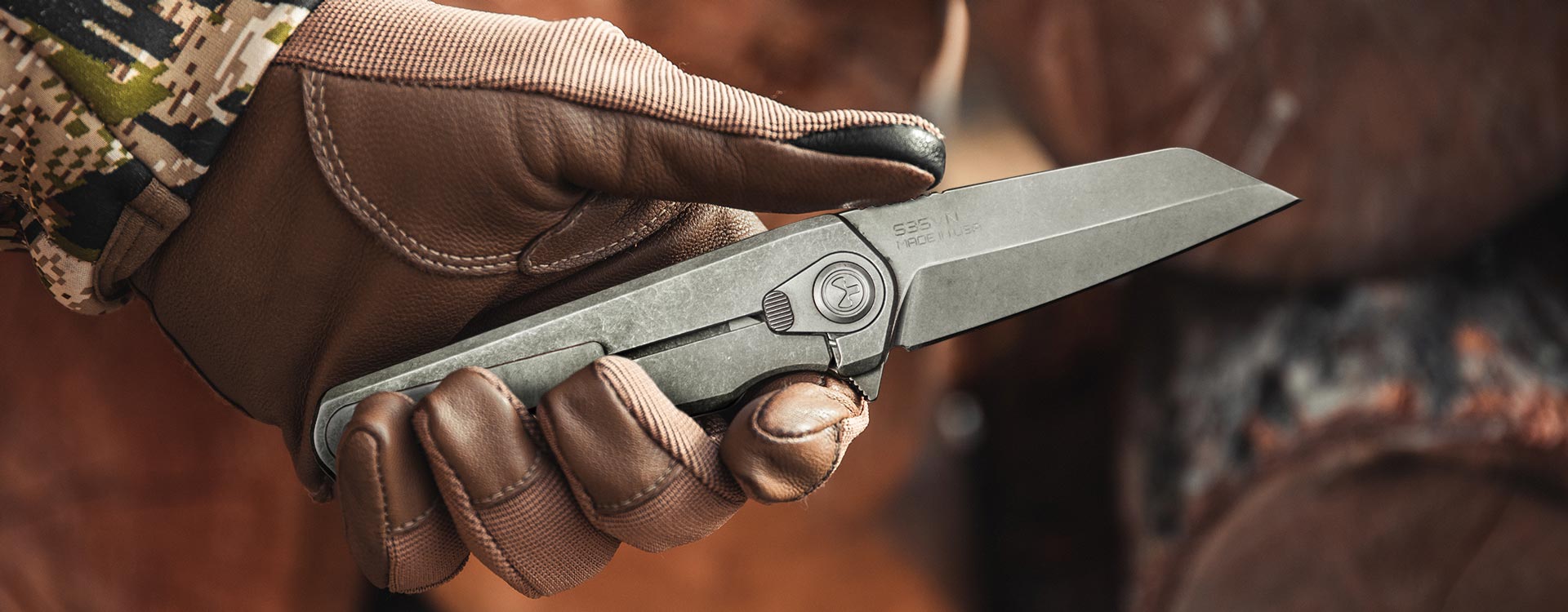 Right side view of deployed Stonewashed Magpul Rigger being held by a brown Magpul-gloved hand