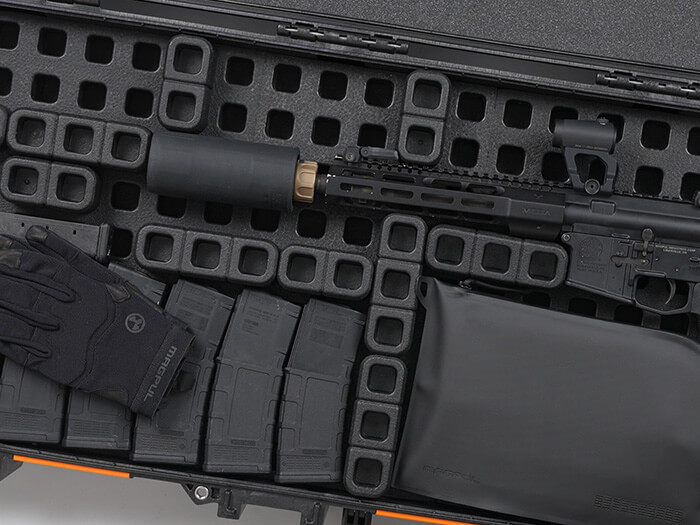 Closeup of inside of case showing multiple Magpul DAKA Blocks arranged to secure a suppressed AR and magazines